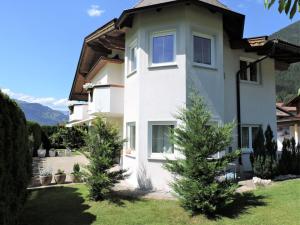 a large white house with trees in the yard at Apartment Monika-2 by Interhome in Gattererberg