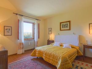 a bedroom with a bed and a large window at Apartment Casetta by Interhome in Poggibonsi