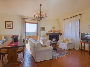 a living room with white furniture and a fireplace at Apartment Casetta by Interhome in Poggibonsi