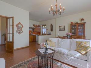 a living room with a white couch and a table at Apartment Casetta by Interhome in Poggibonsi