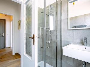 a bathroom with a glass shower and a sink at Holiday Home Villetta ai Pini-1 by Interhome in Calceranica al Lago