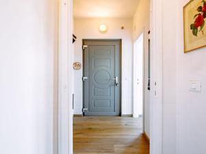 a hallway with a blue door in a house at Holiday Home Villetta ai Pini-1 by Interhome in Calceranica al Lago +27 photos