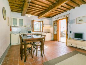 a kitchen with a table and chairs and a television at Apartment Francigena-1 by Interhome in Castelnuovo D'elsa