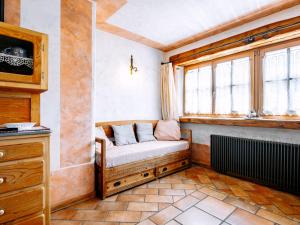 a couch sitting in a room with a window at Apartment Canada by Interhome in Sanzeno