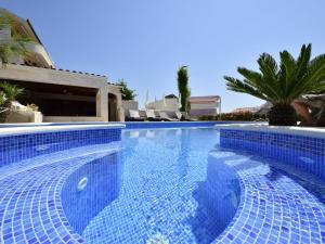 a large swimming pool with blue tiles on it at Apartment Villa Andjelka-1 by Interhome in Trogir