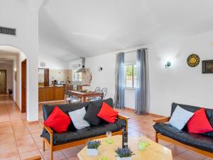 a living room with two couches and a table at Holiday Home Monte Quercus by Interhome in Porches