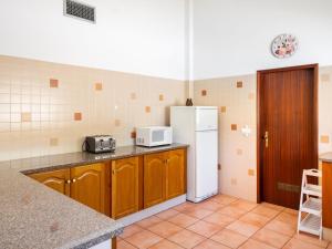 a kitchen with a refrigerator and a counter top at Holiday Home Monte Quercus - PRH100 by Interhome in Porches