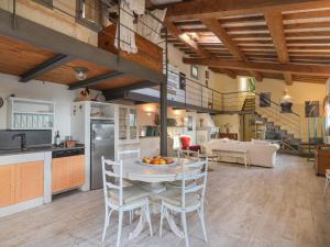 a kitchen and living room with a table and chairs at Holiday Home L'Orlo del Bosco by Interhome in Levane