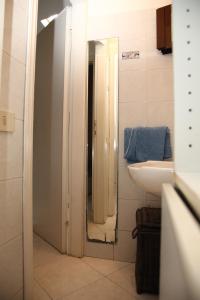 a bathroom with a sink and a mirror at Villini Sulla Spiaggia in Capoliveri