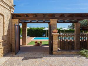 an entrance to a house with a wooden gate at Holiday Home Borgo Agrituristico Il Pino-2 by Interhome in Crecchio
