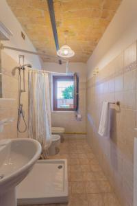 a bathroom with a sink and a toilet and a window at Holiday Home Borgo Agrituristico Il Pino-2 by Interhome in Crecchio +13 photos