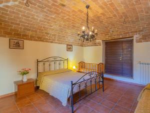 a bedroom with a bed and a brick wall at Holiday Home Borgo Agrituristico Il Pino-2 by Interhome in Crecchio
