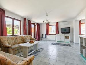 a living room with two couches and a tv at Holiday Home Lago by Interhome in Tihany