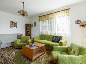a living room with green couches and a coffee table at Holiday Home Dahlia by Interhome in Fonyód