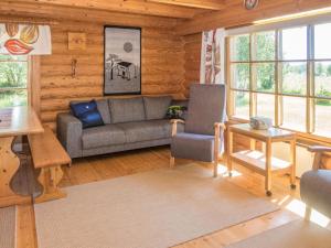 a living room with a couch and a table at Holiday Home Ruka-kitkan käki by Interhome in Säkkilänvaara