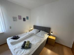 ノルトダイヒにあるApartment Schwalbennest I by Interhomeのベッドルーム1室(白いベッド1台、タオル2枚付)