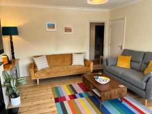 a living room with two couches and a coffee table at Stunning 1-Bed Apartment in Sheringham in Sheringham