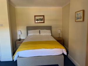 a bedroom with a bed with a yellow blanket at Stunning 1-Bed Apartment in Sheringham in Sheringham