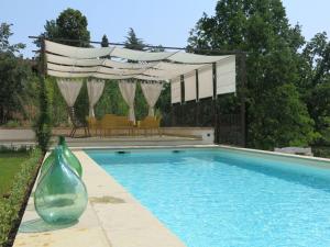 a swimming pool with a vase in a yard at Holiday Home Tenuta Margherita by Interhome in Portacomaro