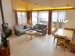 a living room with a couch and a table at Apartment Rehli by Interhome in Beatenberg