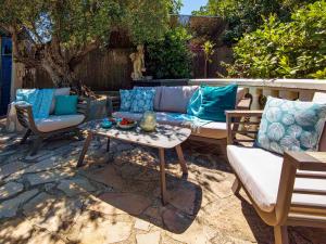 a patio with a couch and a table and chairs at Holiday Home Mabrouk by Interhome in Jávea