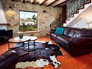 a living room with a leather couch and a table at Holiday Home Mabrouk by Interhome in Jávea
