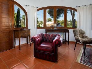 a living room with a chair and a table at Holiday Home Mabrouk by Interhome in Jávea +23 photos
