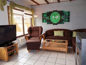 a living room with a couch and chairs and a tv at Holiday Home Ferienwohnpark Silbersee by Interhome in Frielendorf +36 photos