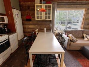 a kitchen and living room with a table and chairs at Holiday Home Hankipolku 7b - ukuli by Interhome in Ylläsjärvi