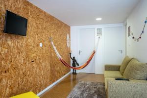 a living room with a hammock on the wall at Villa Amor Perfeito in Vila do Conde