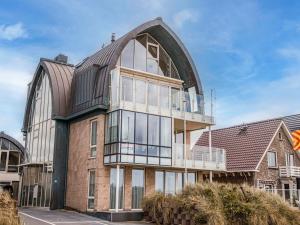 an external view of a building with a large window at Apartment De Zeeparel by Interhome in Egmond aan Zee