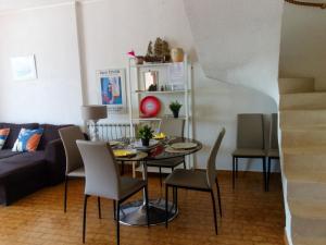 a living room with a table and chairs and a couch at Apartment Le Nirvana-2 by Interhome in Le Grau-du-Roi