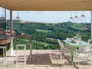 a patio with a table and chairs and a view at Villa Futura by Interhome in Lorgnano