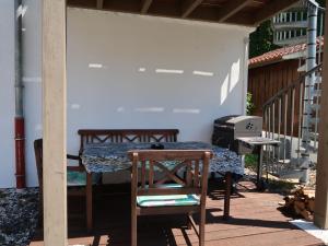 einen Tisch und einen Stuhl auf einer Terrasse mit einem Grill in der Unterkunft Apartment Leon by Interhome in Nentershausen