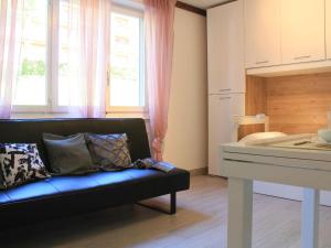 a living room with a couch and a window at Apartment Grenat 8 by Interhome in Villars-sur-Ollon