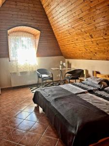 a bedroom with a bed and a table and chairs at Dóra Stúdió Apartmanok in Zalakaros +46 photos