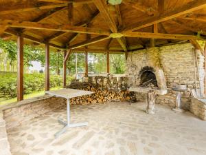 a large outdoor room with a stone fireplace at Holiday Home Bzí by Interhome in Dolní Bukovsko