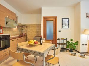 a kitchen with a table with a bowl of fruit on it at Apartment Dani by Interhome in Carriola