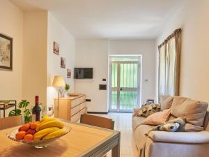 a living room with a bowl of fruit on a table at Apartment Dani by Interhome in Carriola