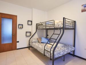 two bunk beds in a room with a door at Apartment Dani by Interhome in Carriola +29 photos
