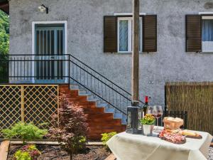 a table in front of a building with a staircase at Apartment Dani by Interhome in Carriola