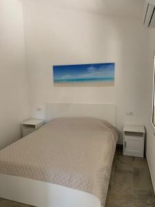 Llit o llits en una habitació de Villetta Ulisse a pochi passi dal mare