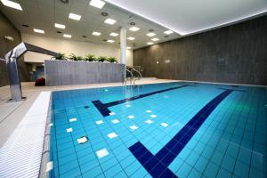 a swimming pool with a blue floor and blue walls at Golden Tulip Gdańsk Residence in Gdańsk