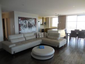 a living room with a couch and a table at 2nd Avenue Beachside Apartments in Gold Coast