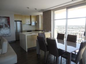 a kitchen and dining room with a table and chairs at 2nd Avenue Beachside Apartments in Gold Coast