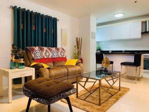 a living room with a couch and a table at Lucky Suite Kandi 2 bedrooms in Angeles