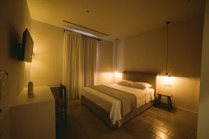 A bed or beds in a room at Yasemi