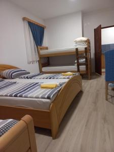 a bedroom with two bunk beds and a table at Apartments Emir in Tuzla