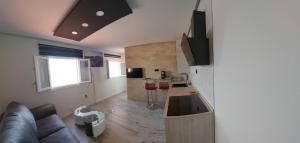 a living room with a couch and a kitchen at Apartamento en primera línea de mar, las Teresitas, Santa Cruz de Tenerife in San Andrés