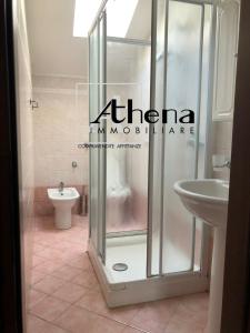 a bathroom with a shower with a sink and a toilet at Riva San Vito 2 in Grado